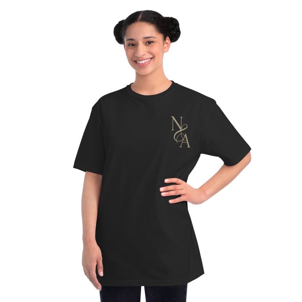 A photo of a female latin model wearing a black color tee shirt with a gold design NA tee shirt design.
