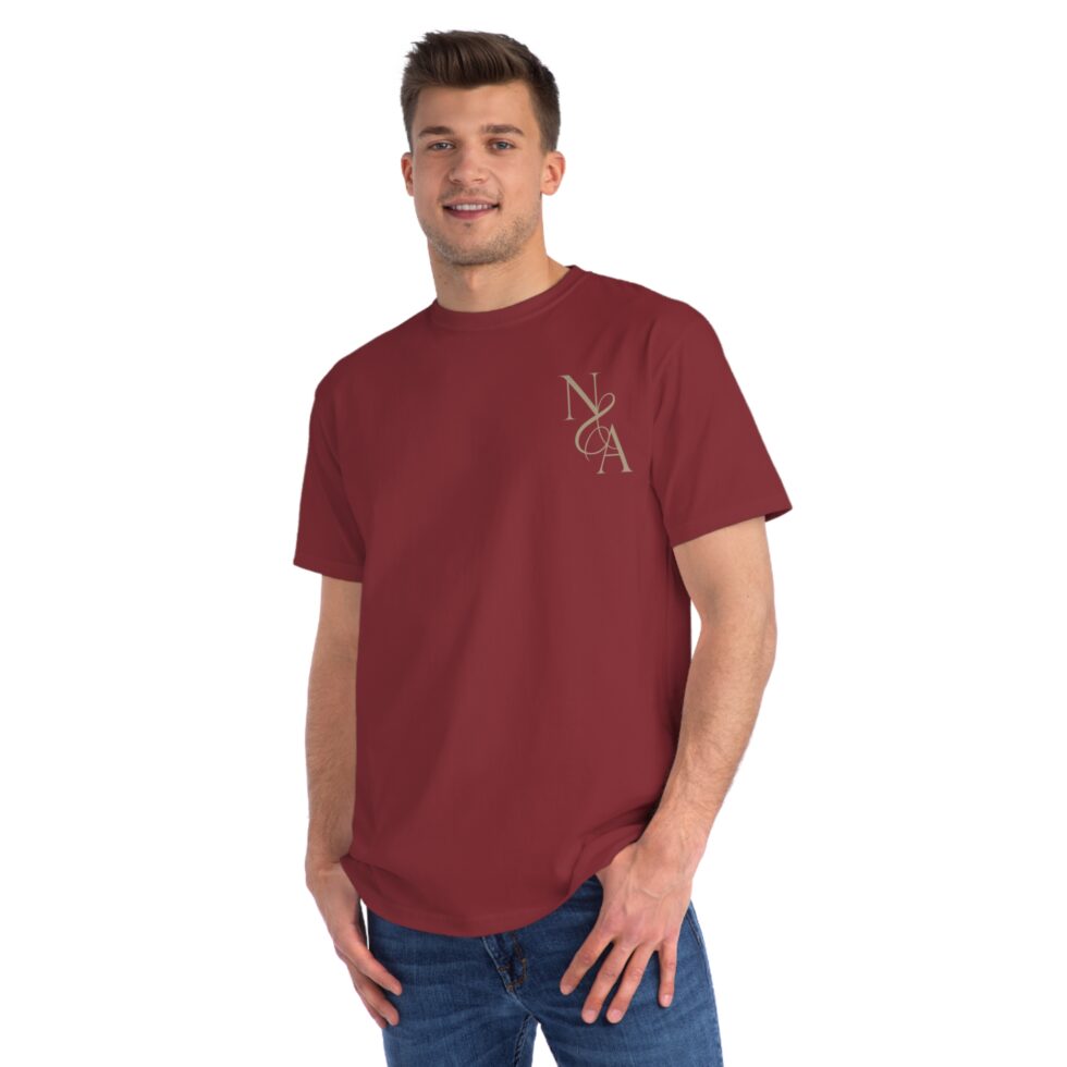 A photo of a male white model wearing a manzanita color tee shirt with a gold design NA tee shirt design.