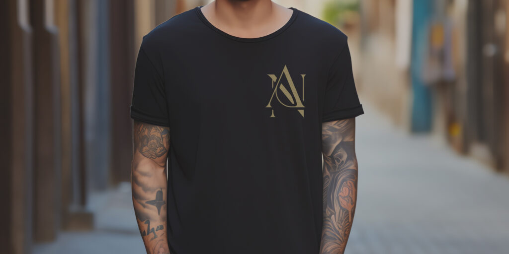Young Man Wearing A Black NA Tee Shirt - NA Tee Shirts | Modern Narcotics Anonymous Apparel Cropped photo of a young man with tattoos wearing a black NA tee shirt.