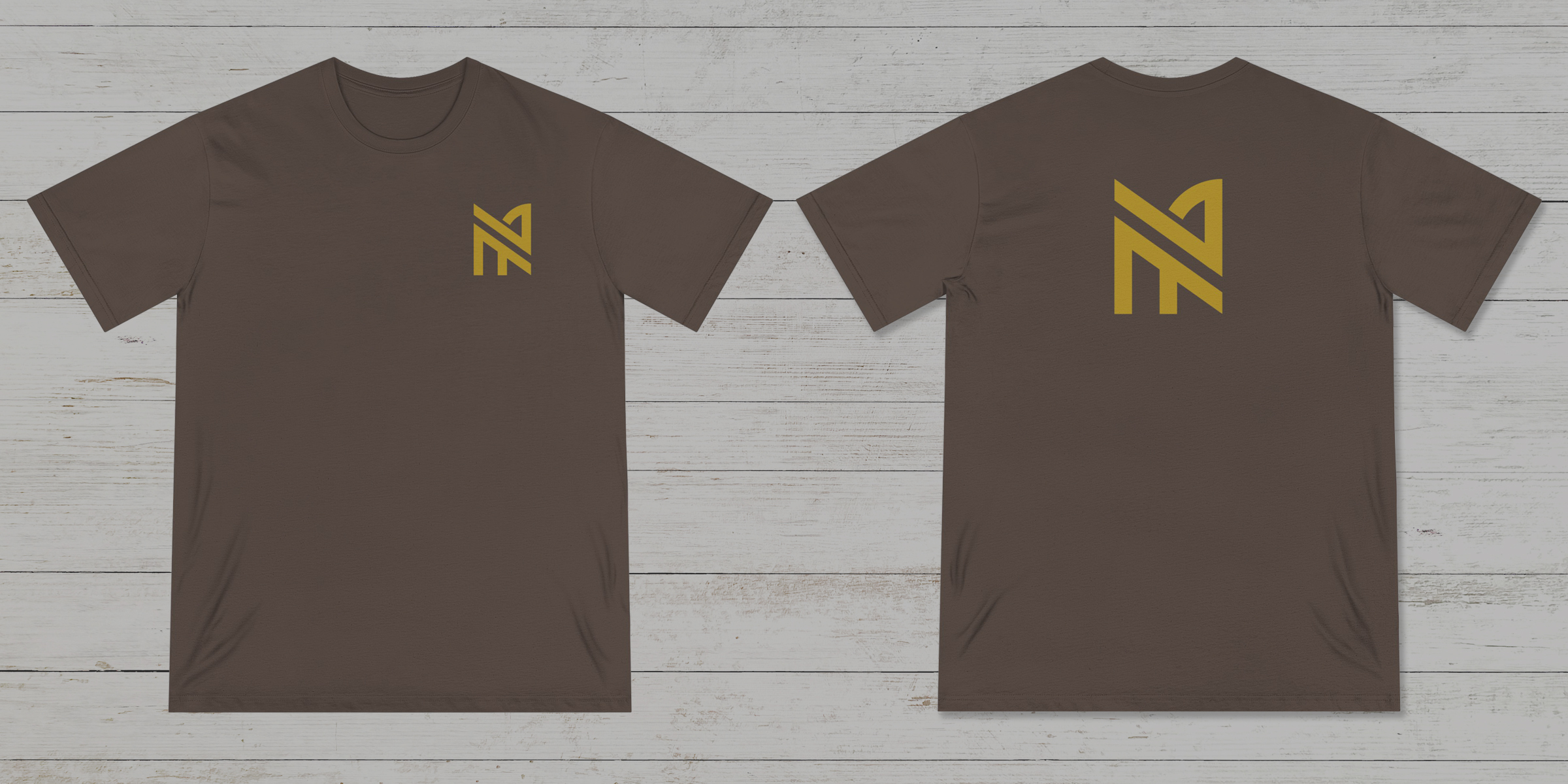 Photo of the front and back of a walnut color NA tee shirt on a old white wood floor background
