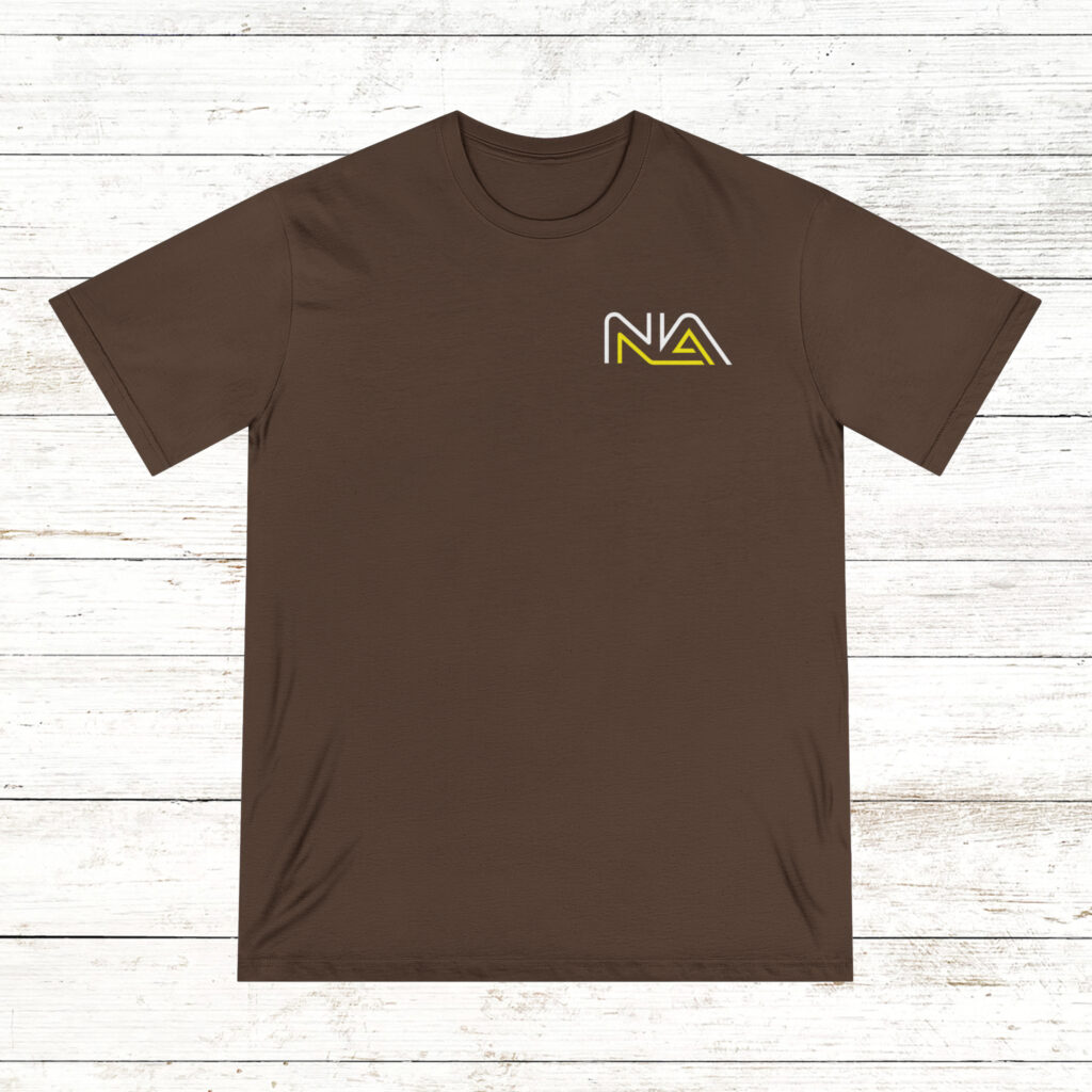 Photo of the front and back of a walnut color NA tee shirt on a old white wood floor background