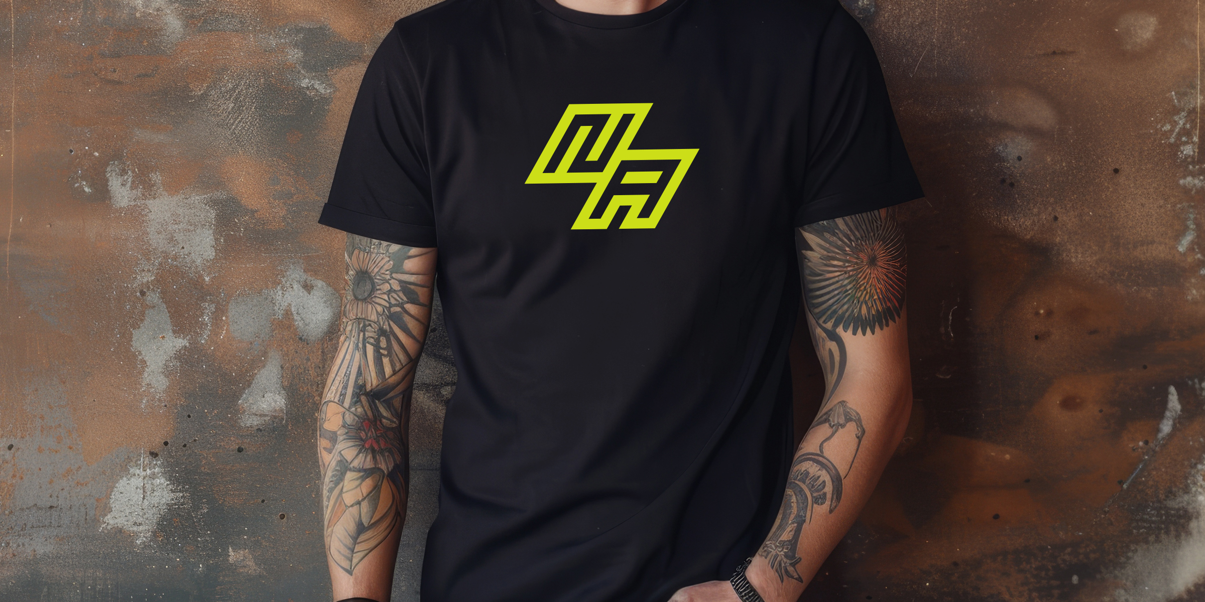 Young man with arm tattoos wearing a black tee NA t-shirt with a neon yellow minimal design.